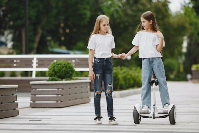 girl on hoverboard with friend