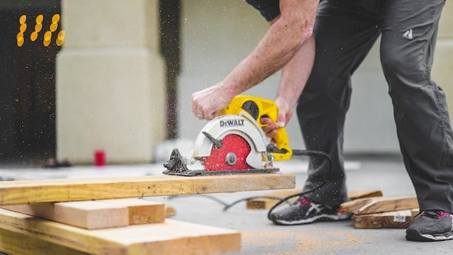man using power saw