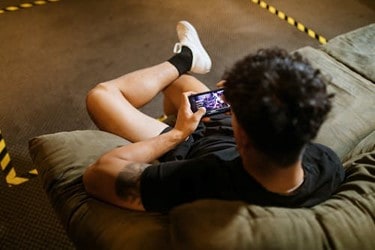 man playing mobile game