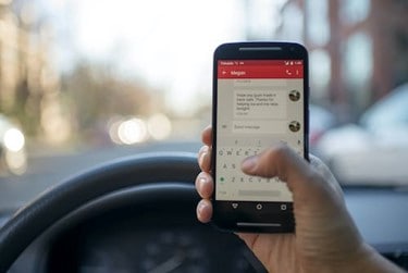 person using phone on car